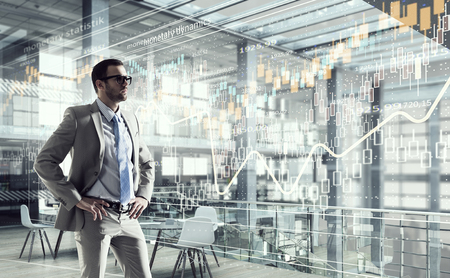 Young elegant businessman in office thinking over businessの写真素材