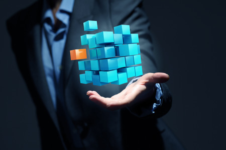 Conceptual image with 3D rendering cube figure in female palmsの写真素材