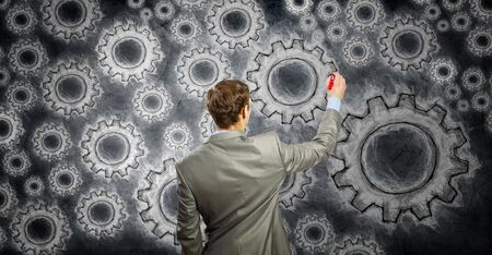 Businessman standing with back and drawing teamwork conceptの写真素材