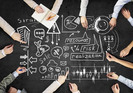 Top view of people hands drawing networking strategyの写真素材