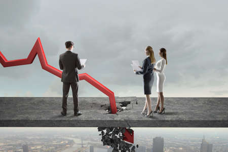 Businesspeople and red decreasing arrow breaking through floor