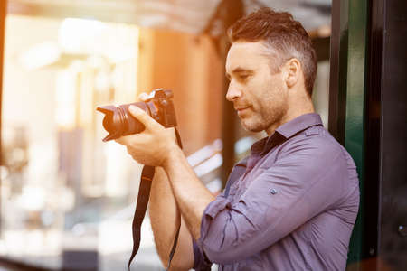 Professional photographer taking picture in cityの写真素材