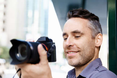 Professional photographer taking picture in cityの写真素材