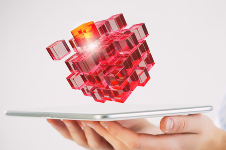 Businessman holding tablet and 3D rendering cube as symbol of problem solvingの写真素材