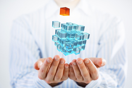 Conceptual image with 3D rendering cube figure in male palmsの写真素材