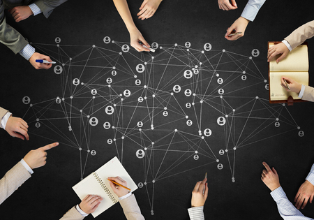 Top view of people hands drawing networking strategyの写真素材