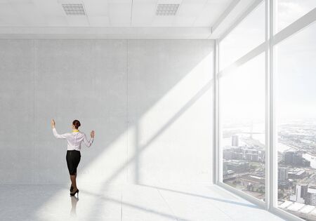 Young successful businesswoman in white office interiorの写真素材