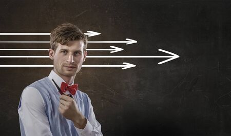 Businessman smoking pipe and arrows and thoughts coming out of his headの写真素材