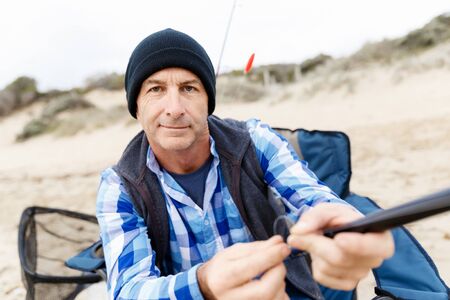 Picture of fisherman fishing with rodsの写真素材