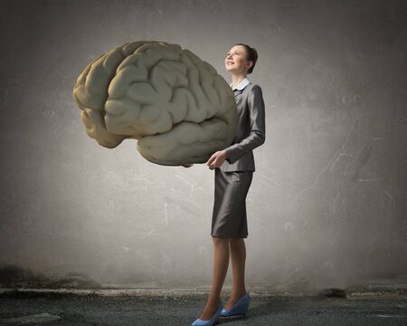 Attractive businesswoman holding big brain concept in palms