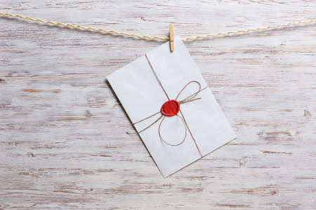 Old envelopes hanging on rope fixed with clothes pegの写真素材