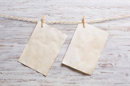 Sheet of old paper hang on clothesline. Place your text
