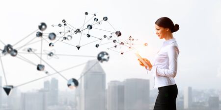 Attractive elegant woman with tablet pc outdoorの写真素材