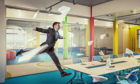 Funny jumping businessman in modern 3D rendering interior. Mixed mediaの写真素材
