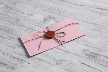 Old post concept with envelope with wax seal on wooden surfaceの写真素材
