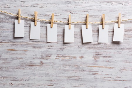 Sheets of old paper hang on clothesline. Place your textの写真素材