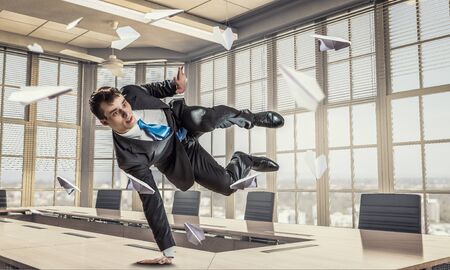 Funny jumping businessman in modern 3D rendering interior. Mixed mediaの写真素材