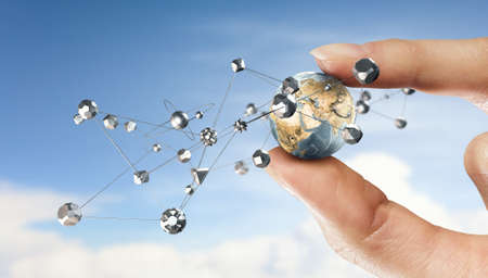 Female hand holding Earth planet between fingers. Elements of this image are furnished by NASAの写真素材