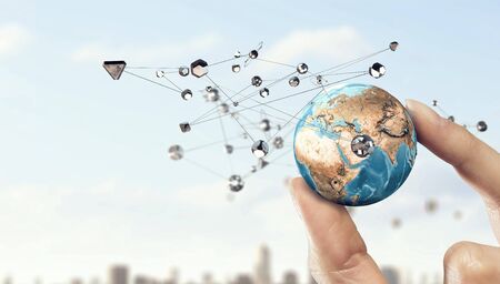 Female hand holding Earth planet between fingers. Elements of this image are furnished by NASAの写真素材