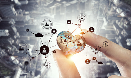 Female hand holding Earth planet between fingers. Elements of this image are furnished by NASAの写真素材