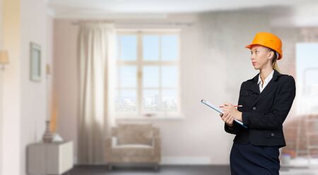 Attractive elegant woman in helmet in modern interior. Mixed mediaの写真素材