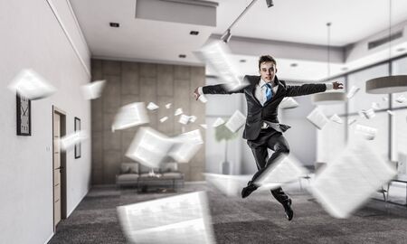 Funny jumping businessman in modern 3D rendering interior. Mixed mediaの写真素材
