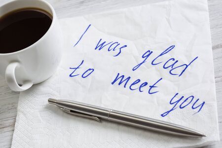 Romantic message written on napkin and cup of coffee on wooden tableの写真素材