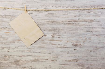 Sheet of old paper hang on clothesline. Place your textの写真素材