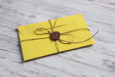 Old post concept with envelope with wax seal on wooden surfaceの写真素材