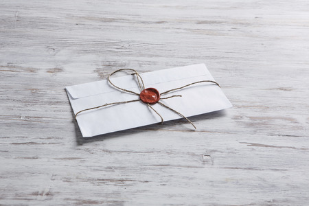 Old post concept with envelope with wax seal on wooden surfaceの写真素材