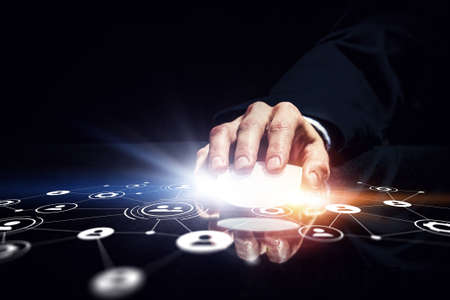 Hand of businessman on dark 3D rendering background using wireless mouse