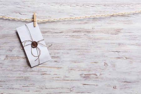 Old envelopes hanging on rope fixed with clothes peg