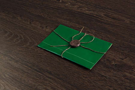 Old post concept with envelope with wax seal on wooden surface