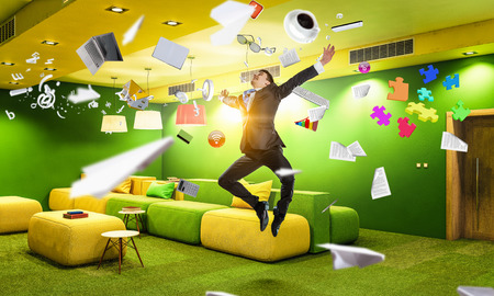 Funny jumping businessman in modern 3D rendering interior. Mixed mediaの写真素材