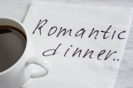 Romantic message written on napkin and cup of coffee on wooden tableの写真素材