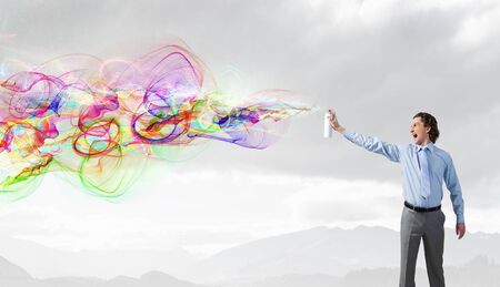Concept of creativity with businessman spraying paint from balloon