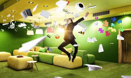 Funny jumping businessman in modern 3D rendering interior. Mixed media