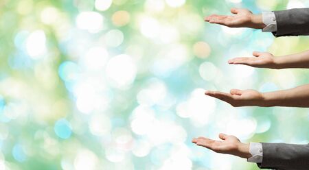 Group of people with hands up showing gestures