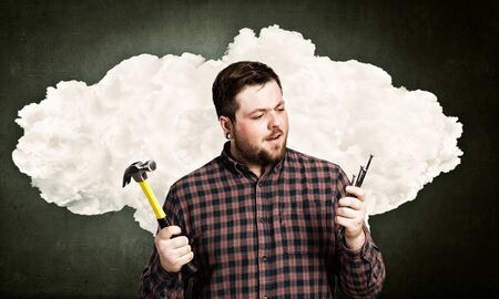 Handyman with hammer and nails in interior