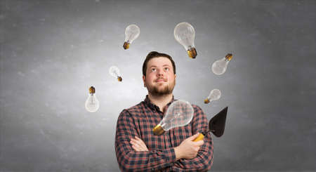 Good looking caucasian manual worker with spatula tool inside houseの写真素材