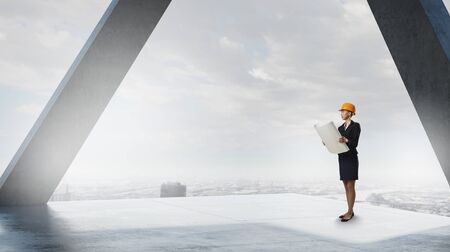 Attractive elegant woman in helmet in modern interior. Mixed mediaの写真素材