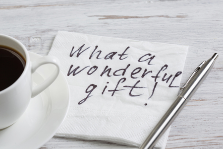 Romantic message written on napkin and cup of coffee on wooden tableの写真素材