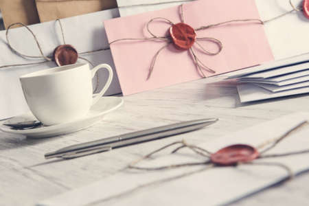 Old post concept with envelope with wax seal on wooden surface