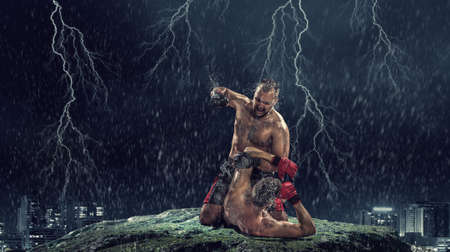 Two strong fighters outdoor demonstrating ultimate fightingの写真素材