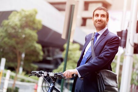 Young businessman with bike outdoorsの写真素材