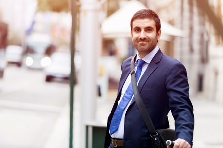 Young businessman with bike outdoorsの写真素材