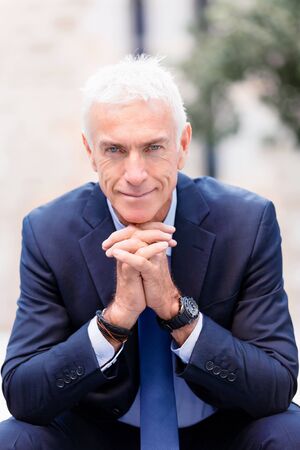 Portrait of confident businessman in suit outdoorsの写真素材