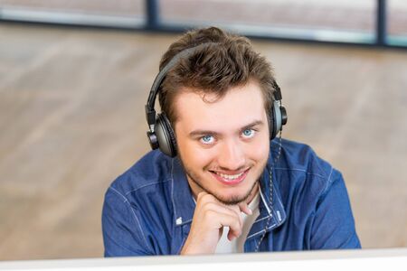 Young man in casual clothes in an office