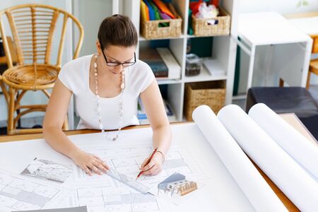 Young woman in casual clothes in an office with drafts