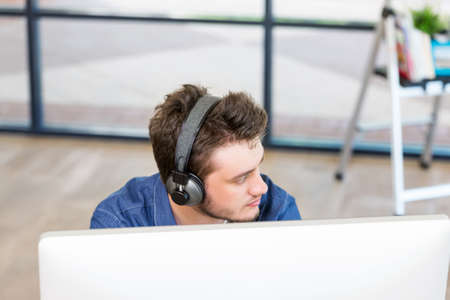 Young man in casual clothes in an officeの写真素材